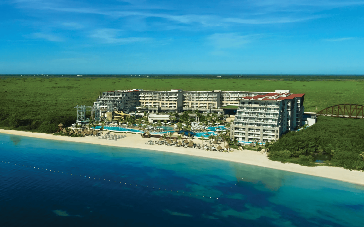 Aerial view of the beachfront pools and tropical grounds at Luxury Natura Resort & Spa